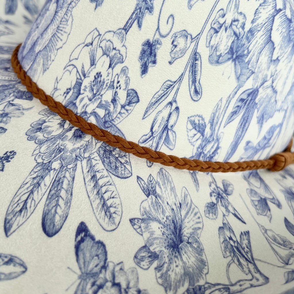 Floral patterned hat with a brown cord