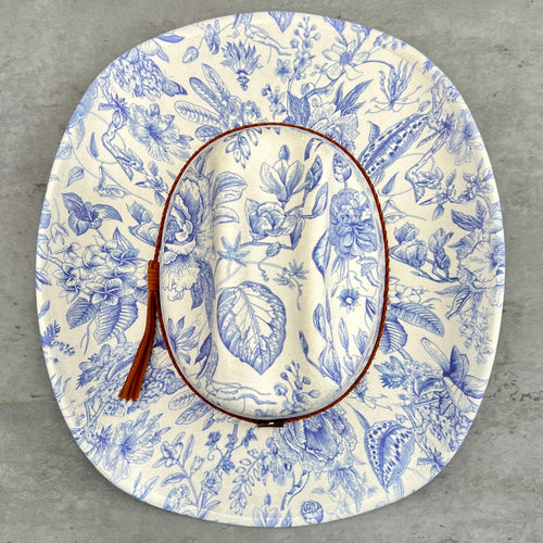 Floral patterned hat with blue designs on a gray background