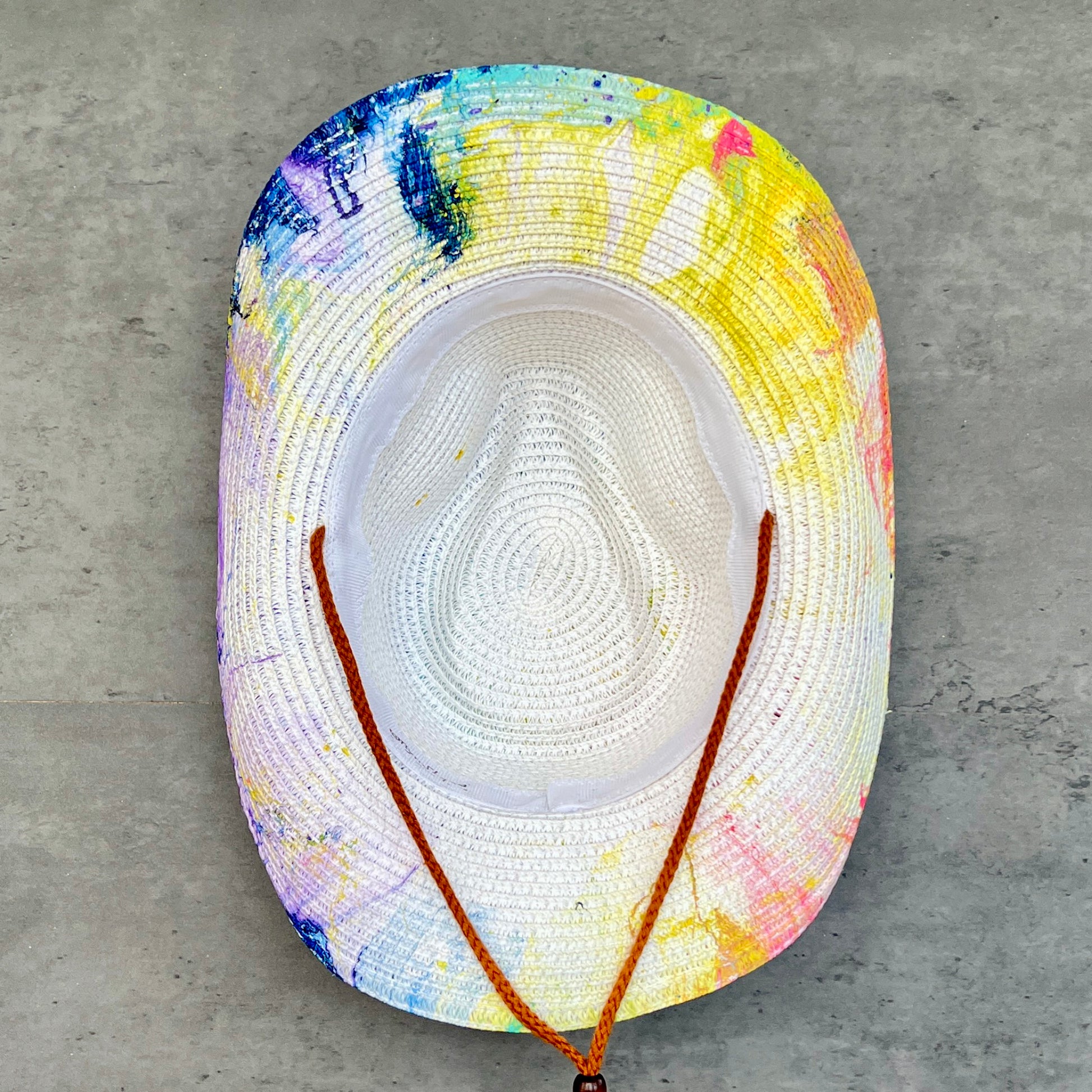 Colorful straw hat with a concrete background