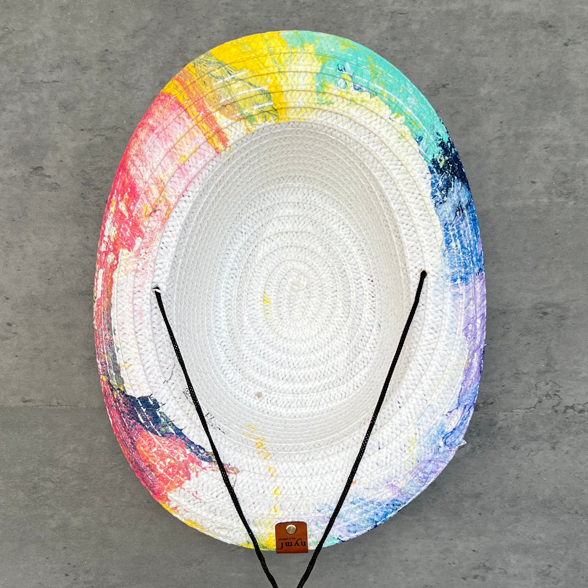Bottom of colorful straw hat on a gray background