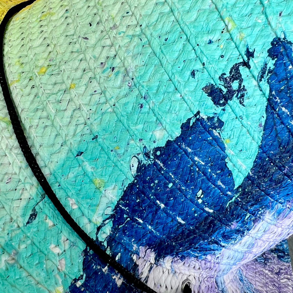 Close-up of a straw hat with blue and green colors