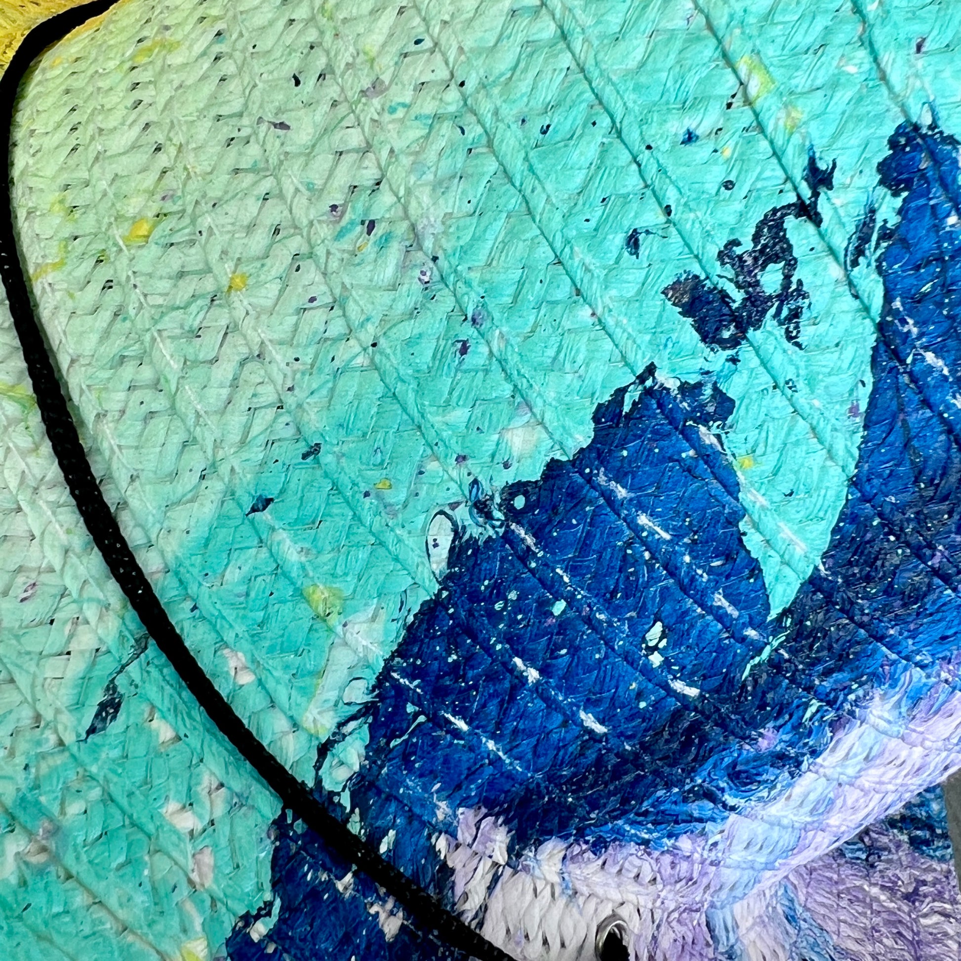 Close-up of a straw hat with blue and green colors