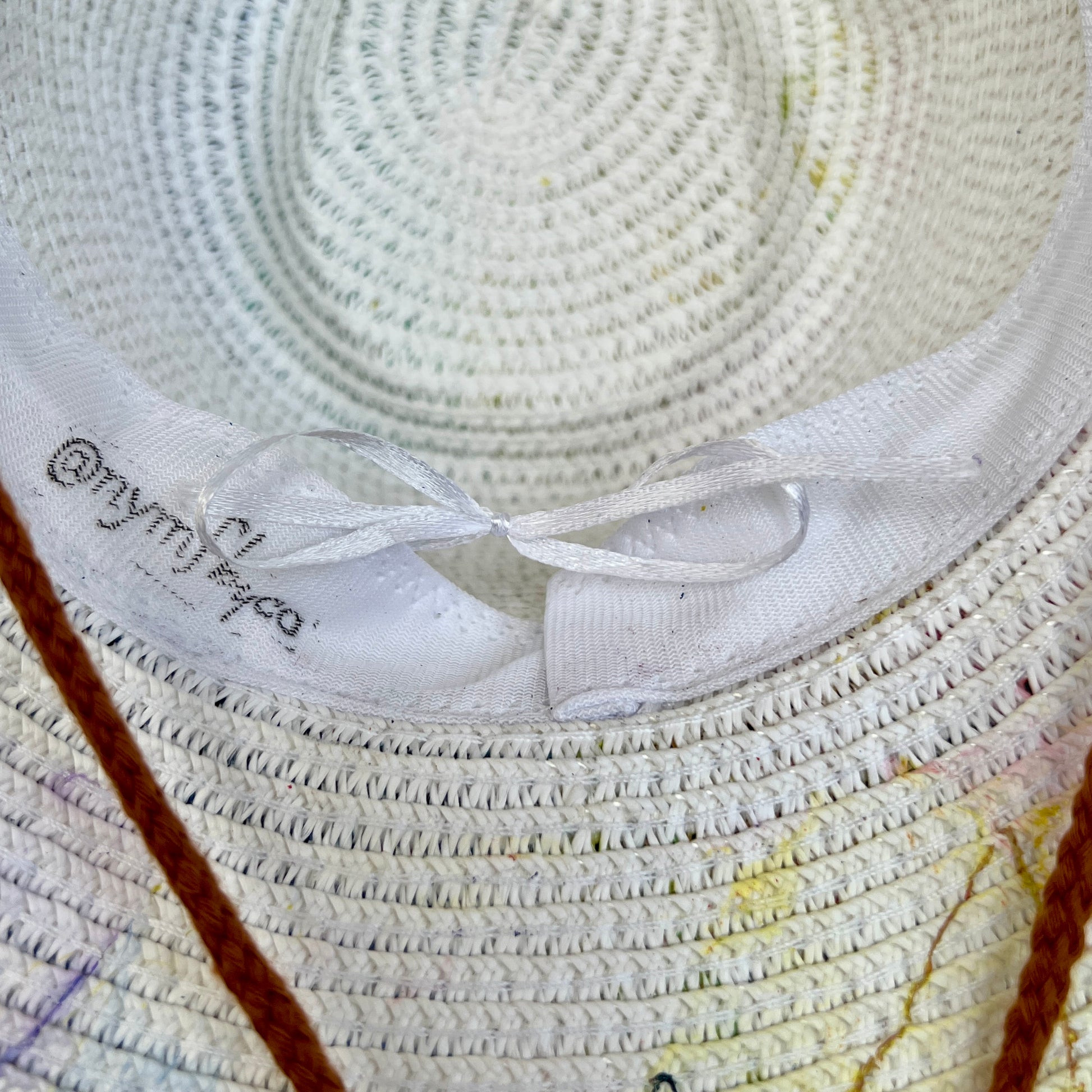 Close-up of a woven hat with a drawstring