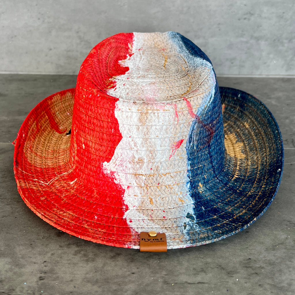 Colorful straw hat with red, white, and blue stripes on a gray surface
