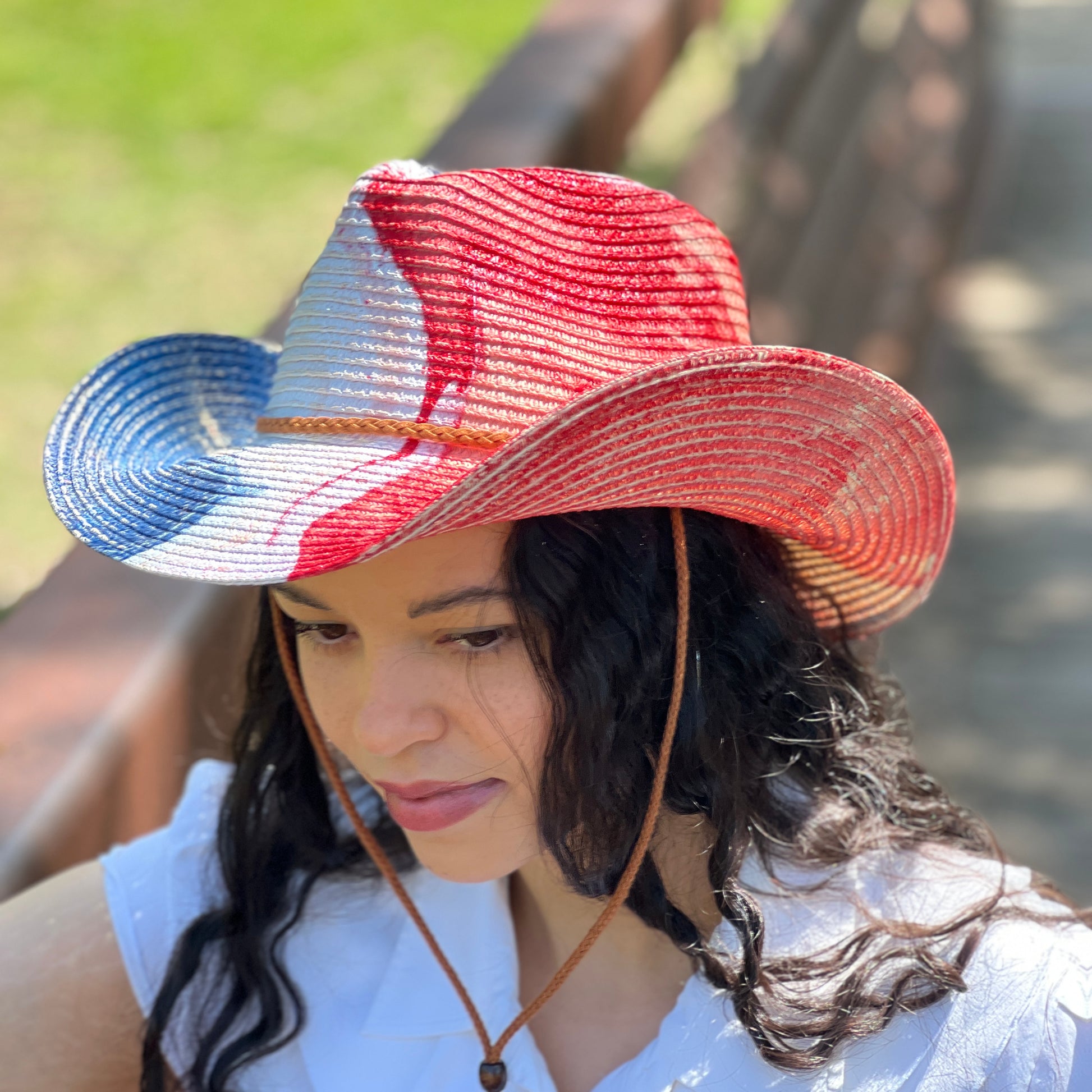 Woman wearing a colorful straw hat with a blurred background