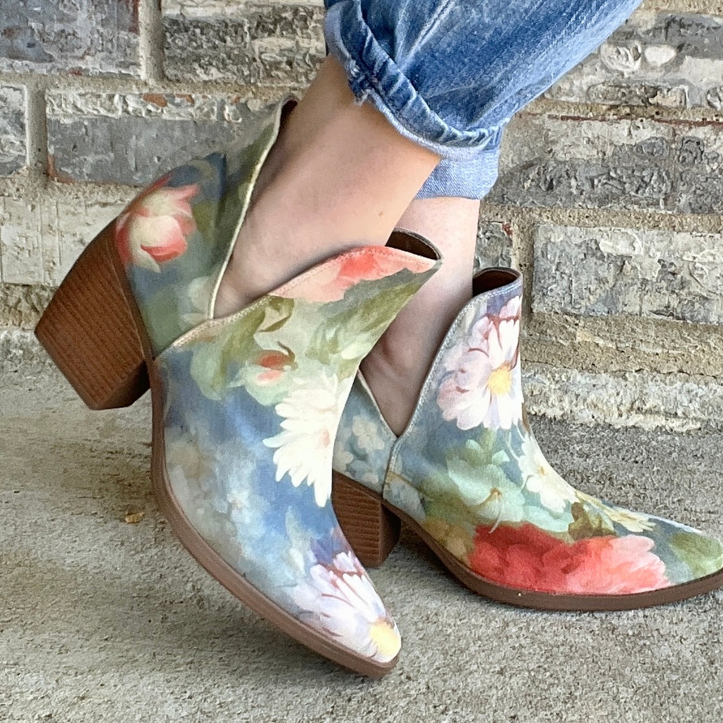 Woman wearing Rococo blue floral ankle boots with cuffed jeans