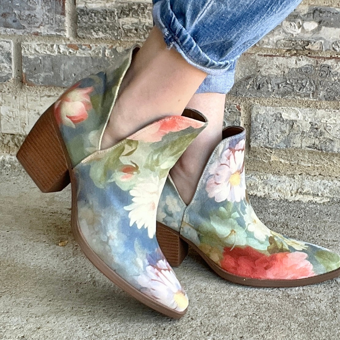 Woman wearing Rococo blue floral ankle boots with cuffed jeans