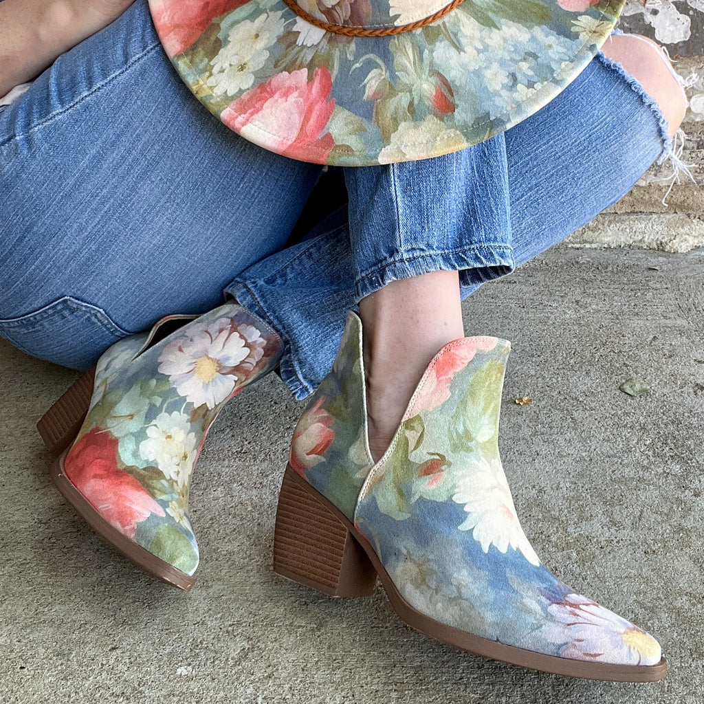 Woman wearing Rococo floral ankle boots and matching blue floral hat