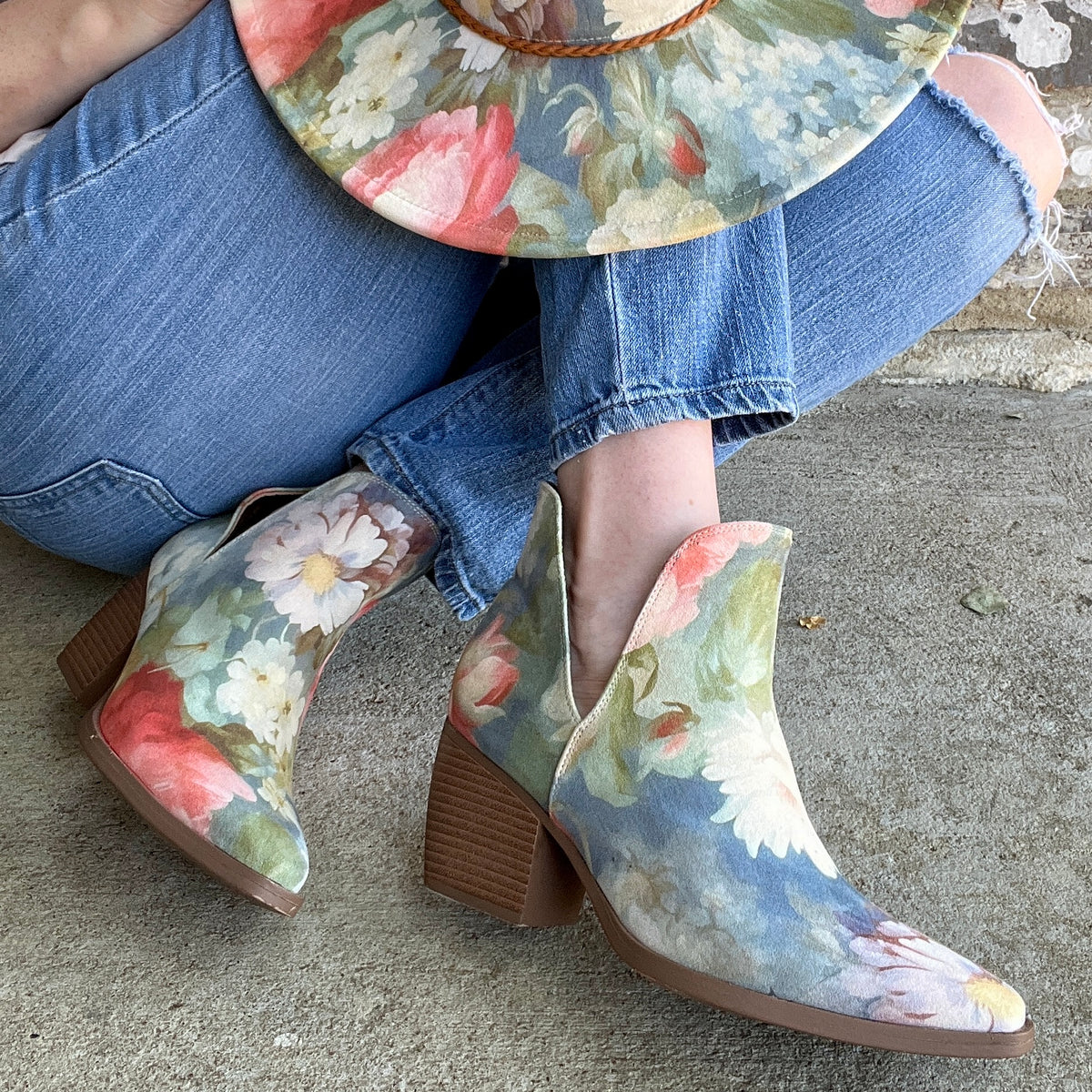 Woman wearing Rococo floral ankle boots and matching blue floral hat