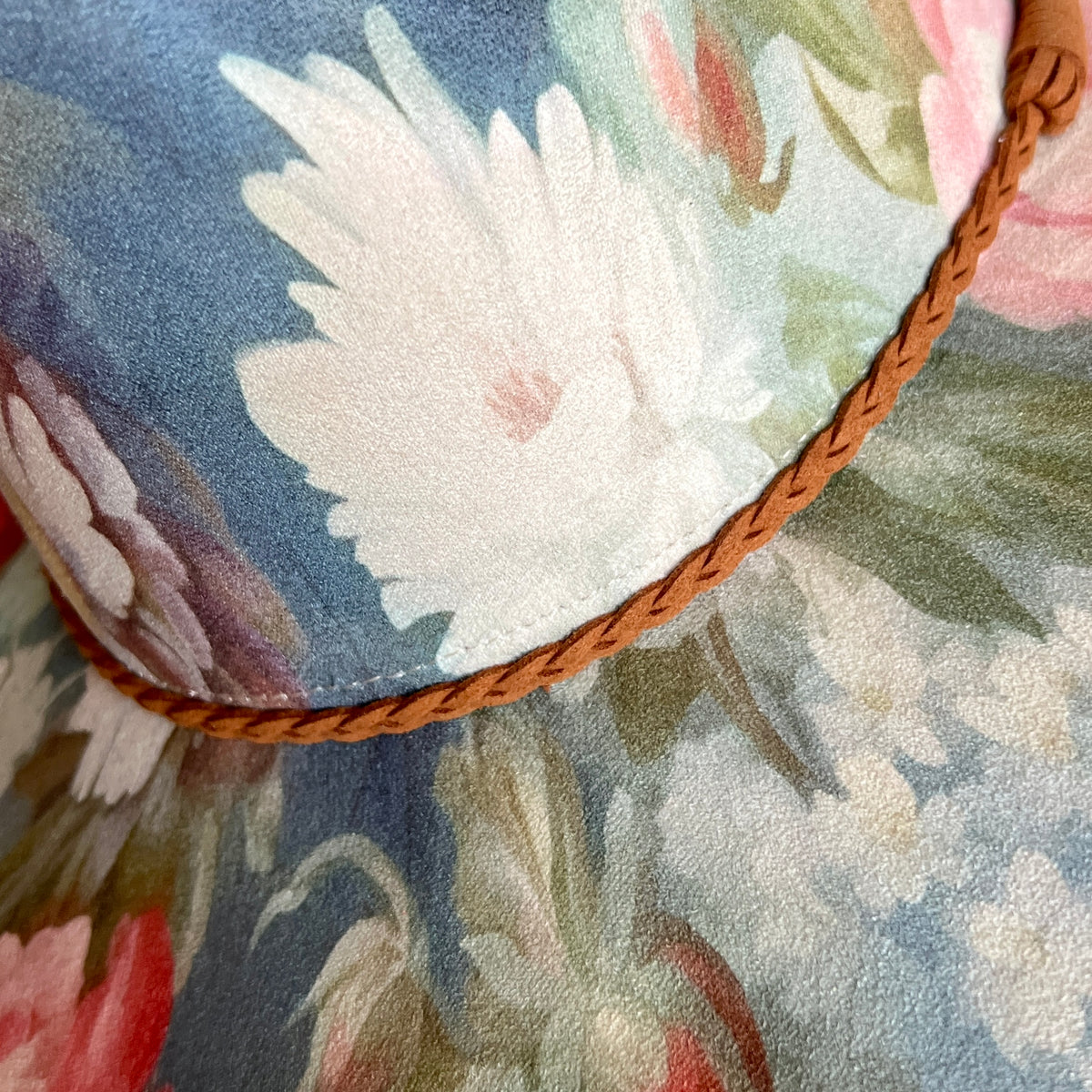 Close-up of painterly floral artwork on rancher hat