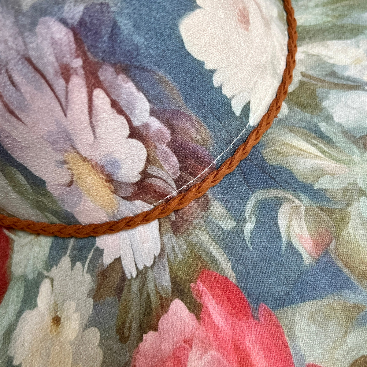 Close-up of brown braided trim on blue floral rancher hat