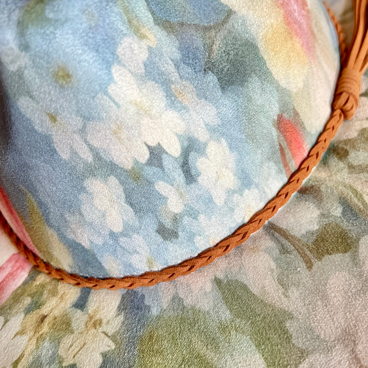 Close-up of painterly blue floral artwork on rancher hat
