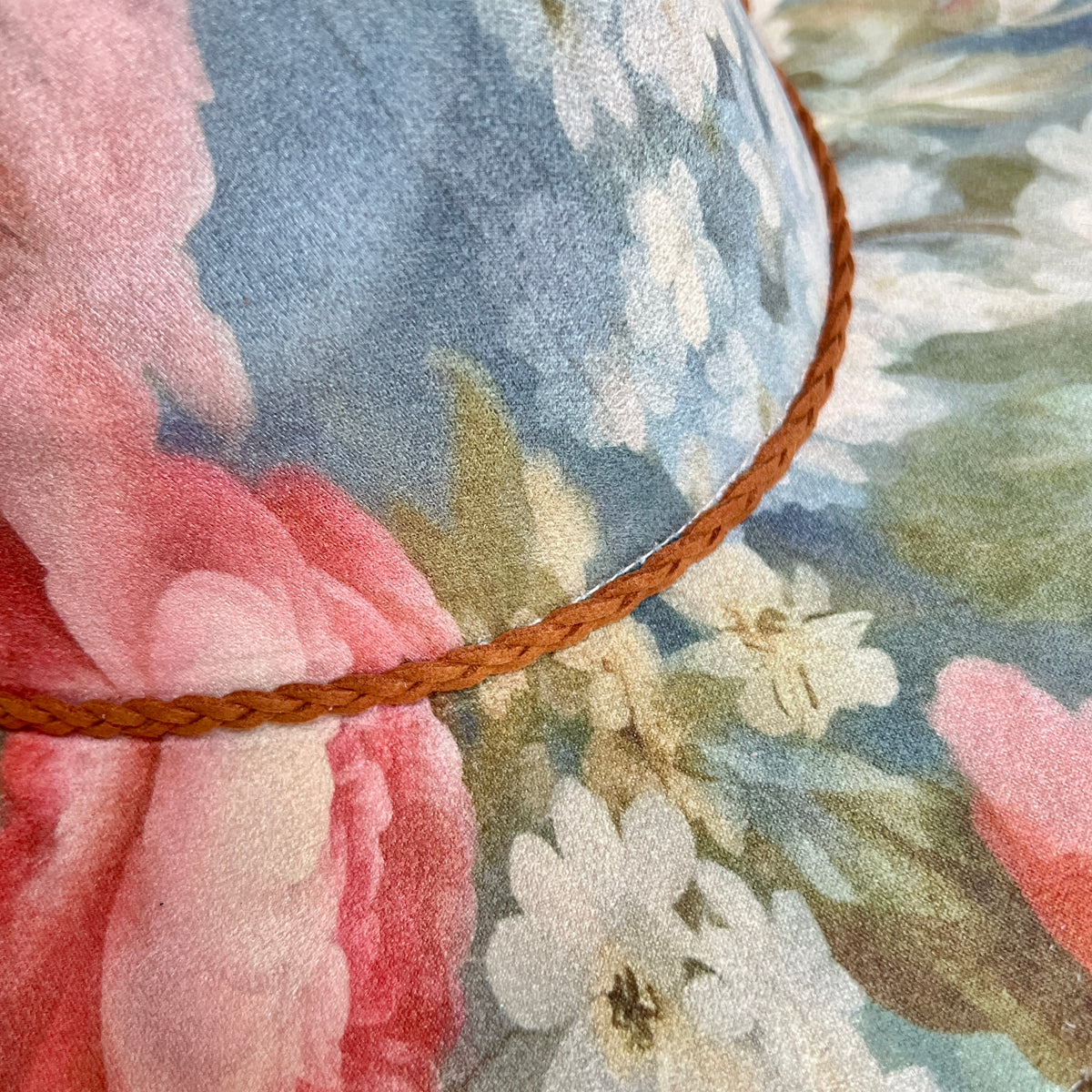Close-up of pink and blue floral print with braided trim