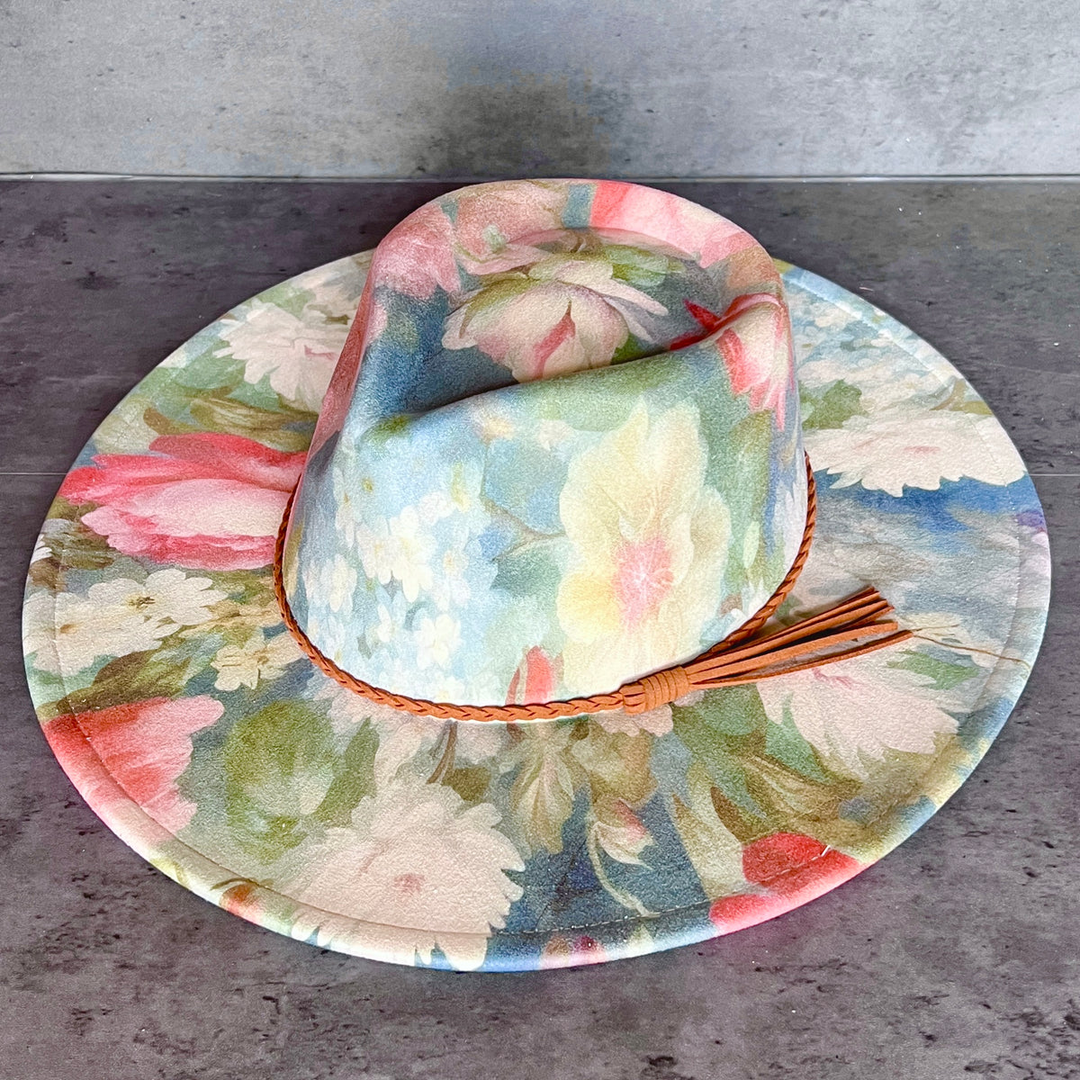 Angled view of blue pink and cream floral rancher hat