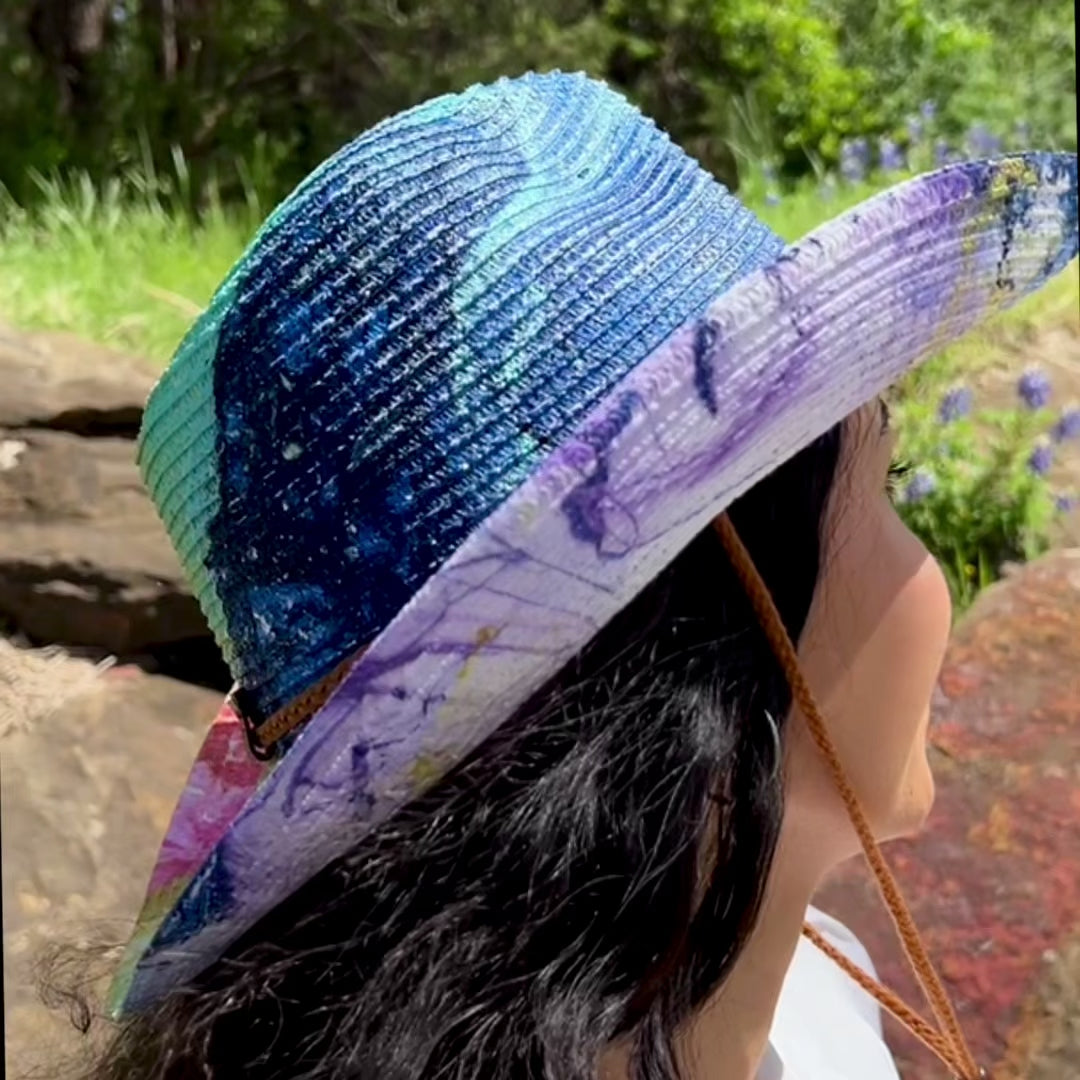 video showing rainbow painted straw cowboy hat on model