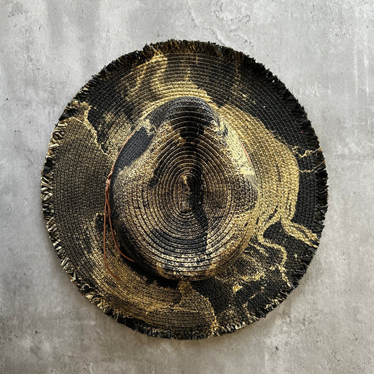 black straw brim rancher hat with fringe has gold paint marbling  and brown leather faux suede cord. sun hat.
